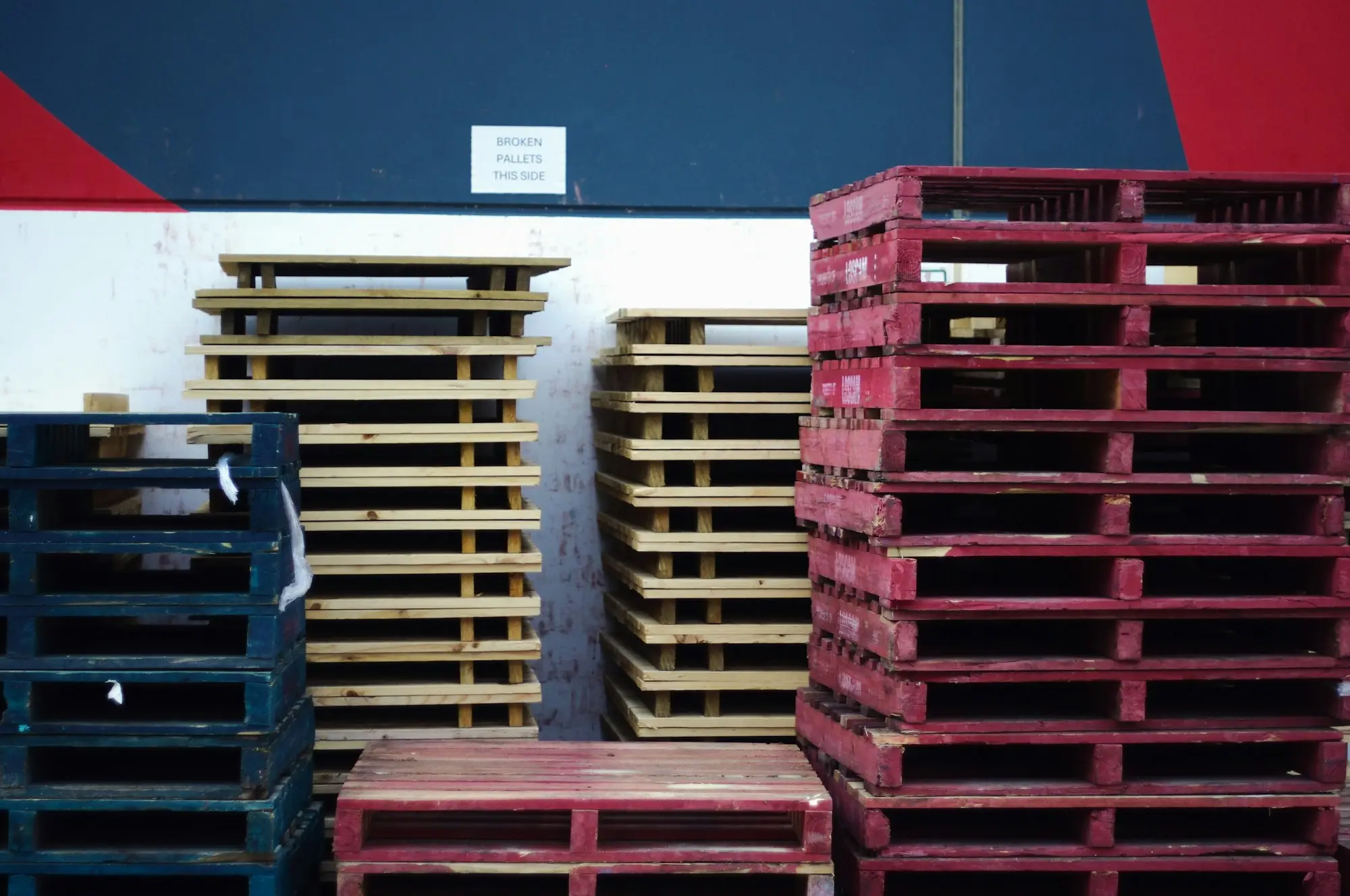 Forklift moving pallets past stacked cartons in a busy Melbourne warehouse dispatch bay